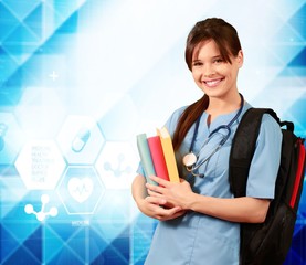 Wall Mural - Attractive young female medical student with backpack and books on white background