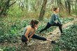 © GAGO IMAGES - Two young beautiful woman exercise in the forest