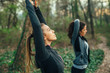 © GAGO IMAGES - Two young beautiful woman exercise in the forest