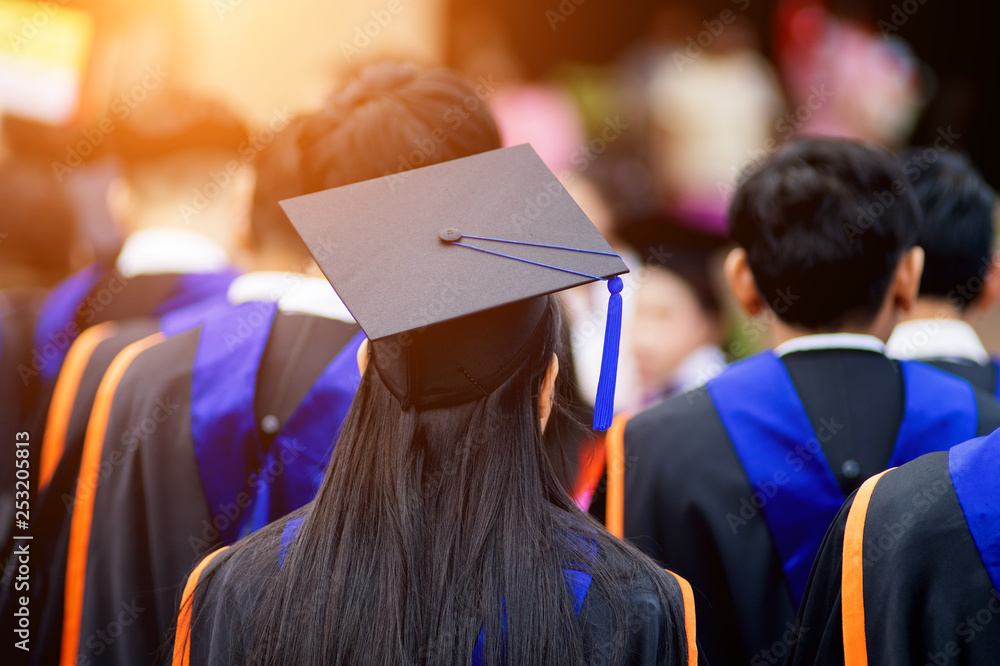Focus Study Gradutation Rear view selective focus of the university graduates crowded in the ...