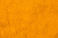 Turmeric Powder Background. Natural Seasoning Texture. Natural Spices And Food Ingredients.