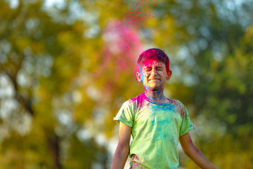 Indian child playing with the color in holi festival