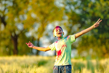 Indian child playing with the color in holi festival