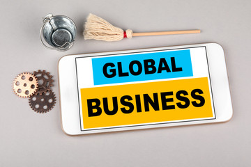 Wall Mural - global business concept. mobile phone on gray table