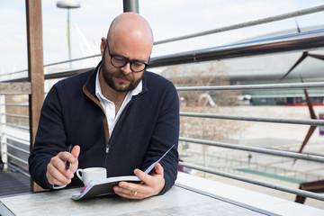 Focused businessman checking daily planner