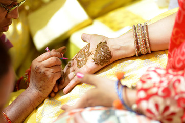 applying henna on hand, bride , traditional Hindu wedding , Rajasthan, India	