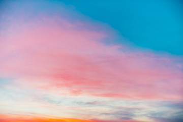 Wall Mural - sunset sky with pink orange light clouds. colorful smooth blue sky gradient. natural background of s
