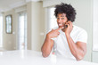 © Krakenimages.com - African American business man talking on the phone very happy pointing with hand and finger