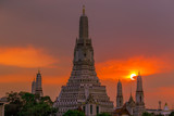 Fototapeta Paryż - Twilight wallpaper in the evening,the sun going back to the horizon,Wat Arun Ratchawaramaram is a temple along the ChaoPhraya River is an important place and a beautiful tourist destination in Bangkok