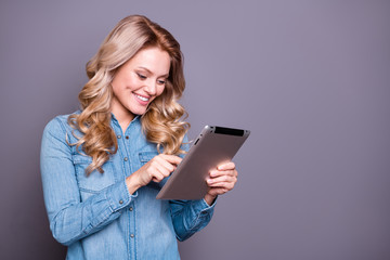 Wall Mural - Portrait of her she nice cute lovely charming attractive cheerful cheery wavy-haired lady wearing blue shirt holding in hands new cool tablet isolated over gray pastel background