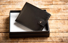 Black Leather Wallet On A Wooden Table