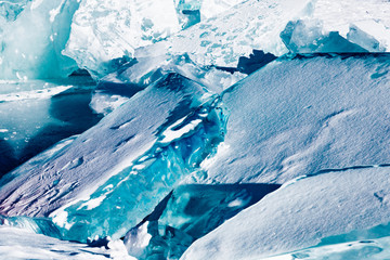 Melting ice cracks. Arctic winter background.