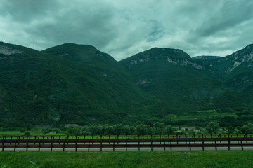 Italy,La Spezia to Kasltelruth train, a wooden bench in front of a mountain