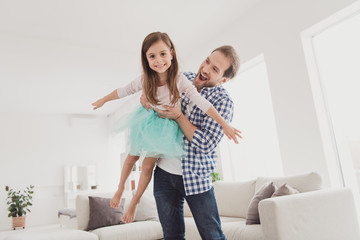 Close up photo two little she her lady girl handsome beard bristle he him his father guy hold hands like airplane flying homey indoors glad togetherness lovely great morning sunday light flat house