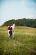 © IdeaBug, Inc. - Medieval Princess with a White Horse in a Meadow - Room for Text