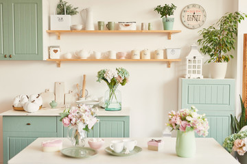 bright kitchen in the style of provence, on the table dishes and a bouquet of flowers in a vase