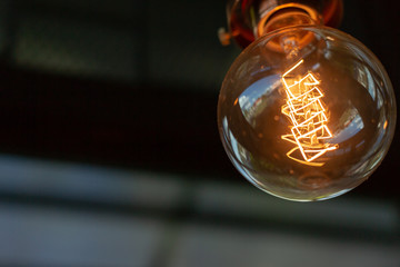 Wall Mural - Close up of Illuminated light bulb with copy space.