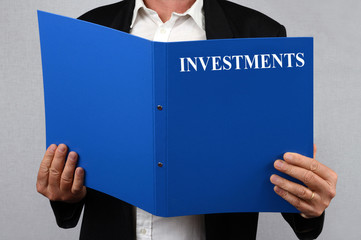 Man reading the investment file