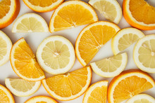 Top View Of Orange And Lemon Slices On White Background