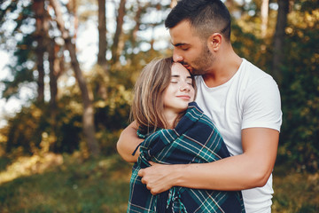 Beautiful couple spend time in a summer park