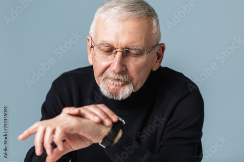 Old Handsome Man With Gray Hair And Beard In Eyeglasses And