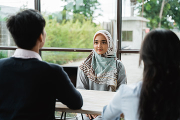 veiled women interviewed as new employees by two human resources departments in the office building