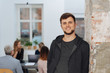 © contrastwerkstatt - Young man in grey hoodie portrait in office