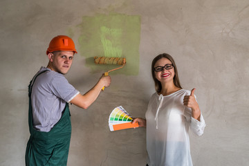 Woman choosing color for painting walls in apartment