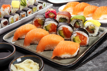 Wall Mural - close up of sashimi sushi set with chopsticks and soy - sushi roll with salmon and sushi roll with smoked eel