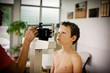 © Erickson Stock - Young boy getting weighed on a scale.