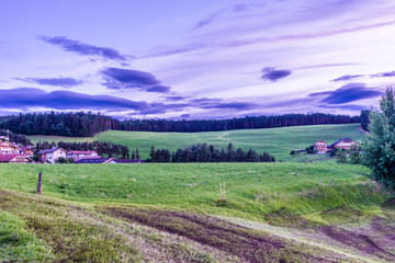 Alpe di Siusi, Seiser Alm with Sassolungo Langkofel Dolomite, a large green field with trees in the background