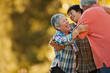 © Erickson Stock - Smiling teenage boy hugging his grandparents.