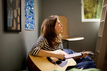 Teenage Girl Playing Her Guitar And Singing.
