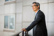 © Erickson Stock - Pensive mature businessman taking a break on a balcony.