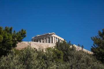 Acropolis of Athens Greece rock and Parthenon on blue sky background, sunny day.