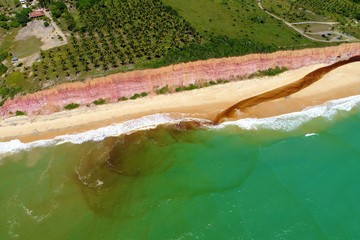 Aerial view of Cumuruxatiba Beach, Prado, Bahia, Brazil. Great landscape. Beautiful beach and river sceneries. Tropical travel. Travel Destination. Vacation travel. Nature scenery.