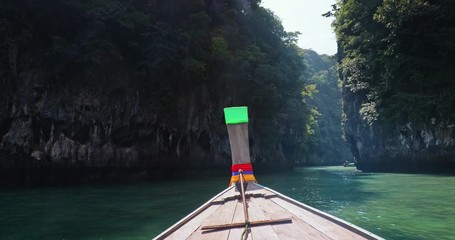 Wall Mural - Travel and tourism in Thailand. Boat floats near coast of Phuket and Krabi