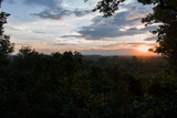 Fototapeta Na ścianę - Sunset over the tropical jungle forest in Siem Reap. Beautiful scenic summer sunlight in Cambodia