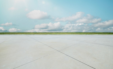 Wall Mural - empty concrete cement floor with green and beautiful cloud sky , noon scene .