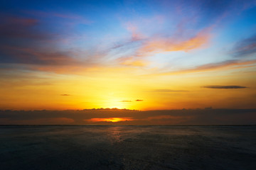 Wall Mural - empty concrete cement floor with beautiful and dramatic golden hour sunset sky .