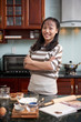 © DragonImages - Teenage girl in kitchen