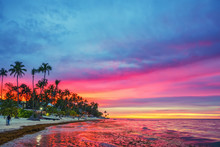 Vibrant Sunset Over Tropical Beach And Palm Trees In Dominican Republic