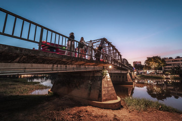 Wall Mural - Colorful lights on the historical Iron Bridge at night time in Chiang Mai, Thailand , HDR Long Exposure..