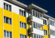 Fragment Of Brightly Colored Apartment Building With Balconies