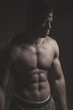 © alfa27 - Toned image of strong afroamerican athletic man with naked perfect shape musculs standing isolated over dark background.