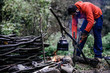 © sercansamanci - Axe and Firewood Logs in Front of an Outdoor Fire