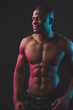 © alfa27 - Attractive African male fighter or boxer posing shirtless, isolated over dark background. Toned and ripped muscular fitness man under dramatic low key lighting, copy space.