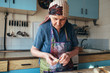 © photoguns - Grandmother cooking, preparing sweet dumpling with cottage cheese