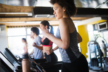 Wall Mural - Fit sportswoman exercising and training at fitness club