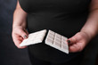 healthy lifestyle decision, sugar reduce, diet, weight loss. overweight woman breaking chocolate bar